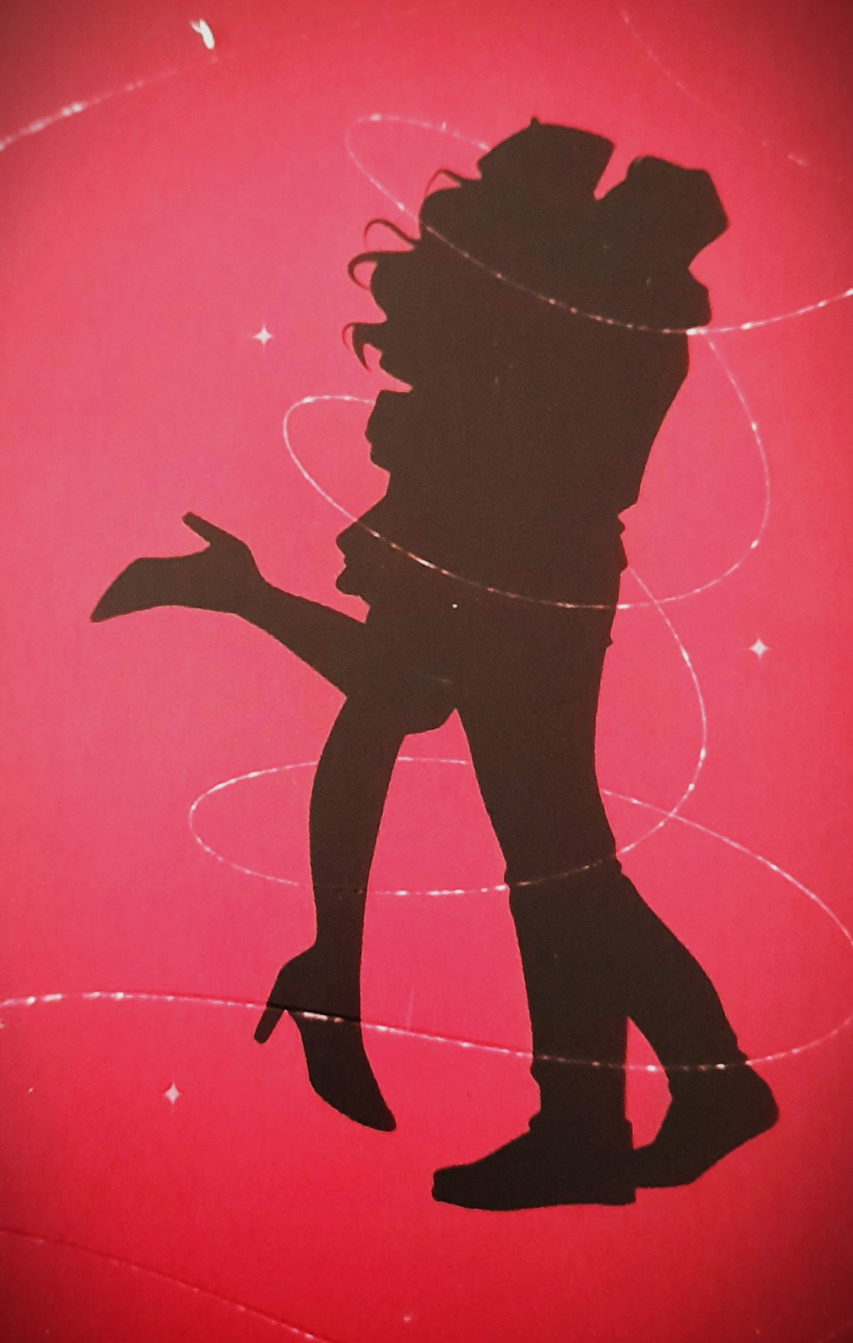 Silhouette noire d’un couple dansant sur fond rouge, avec reflets et fissures blanches visibles.